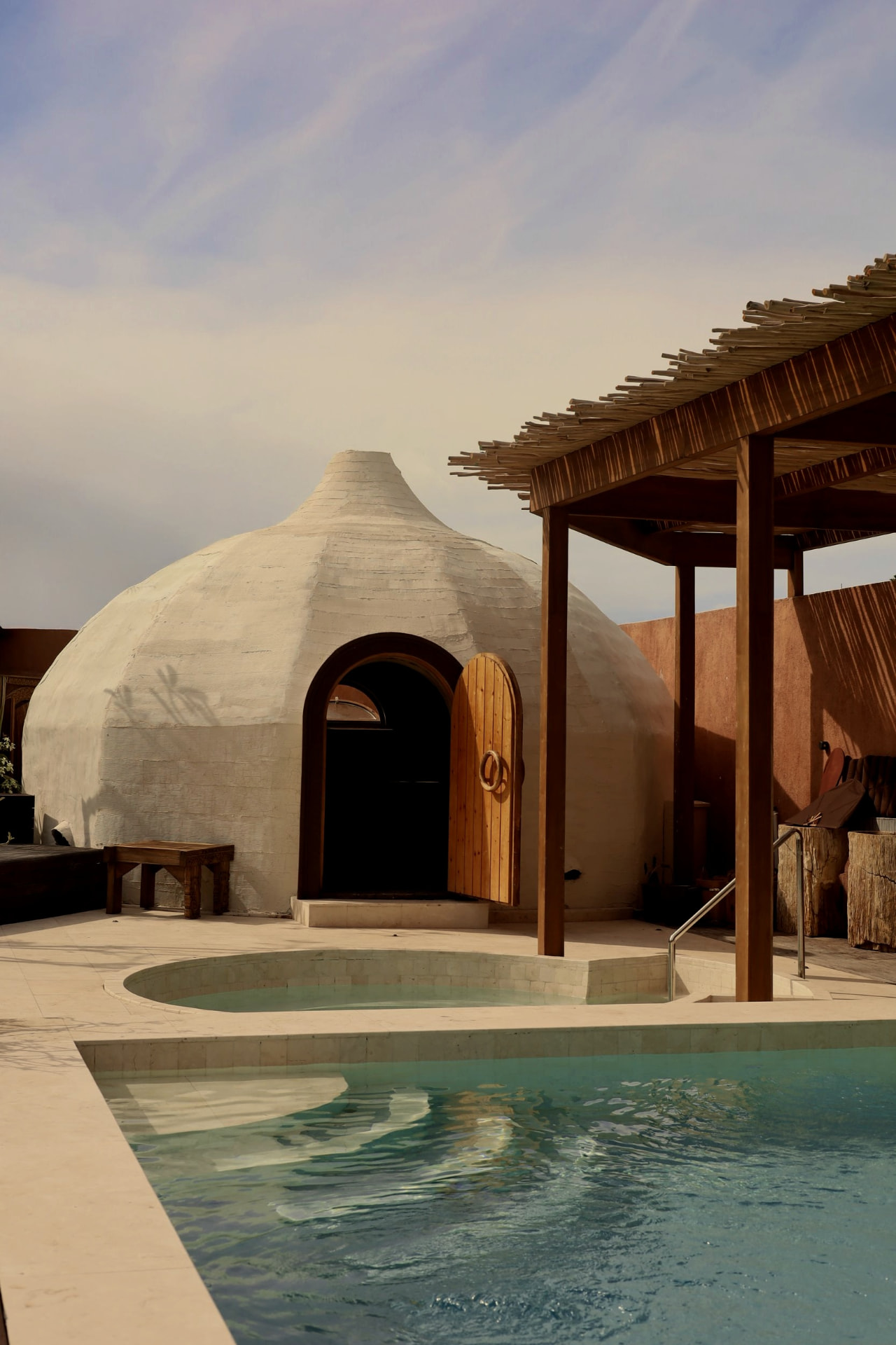 Built thermal environment with dome structure and surrounding pools